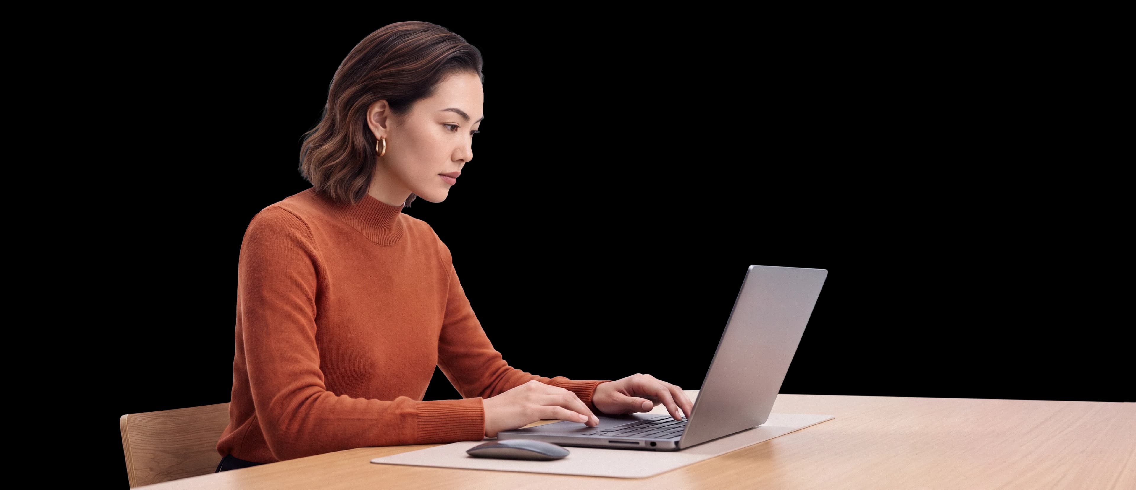 Amara working at her laptop