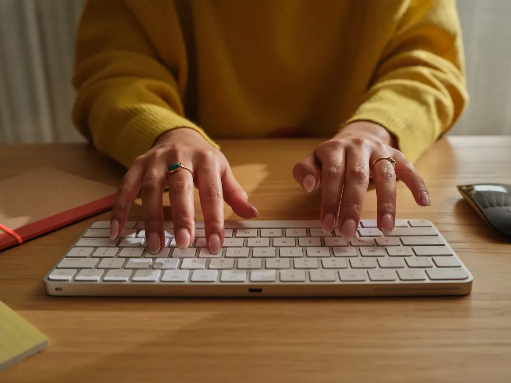Professional rewriting an email with AI on their device